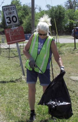 Rotarian and Cushing Lower Elementary Principal Nancy Dowell keeps it clean out on North Kings Hwy.
