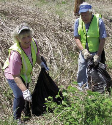 Maria Roberson displays the joys of volunteering with a smile and a trash bag. Dena Morgan and Tyson Branyan were digging in ditches to make sure they cleared all the litter in their section of Kings Highway.