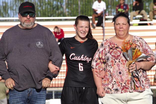 Forward for the Lady Tigers, Kathy Ragen escorted by her parents Gerald and Amanda Regan.
