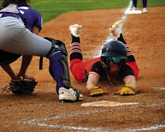 Lady Tiger slow pitch Freshman Alyssa Roe dives into home plate against Hominy last week. Photo by Sarah Townes