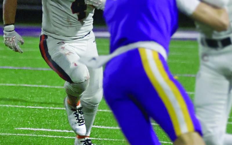 Senior Kellen Fry runs past Pirate defenders.