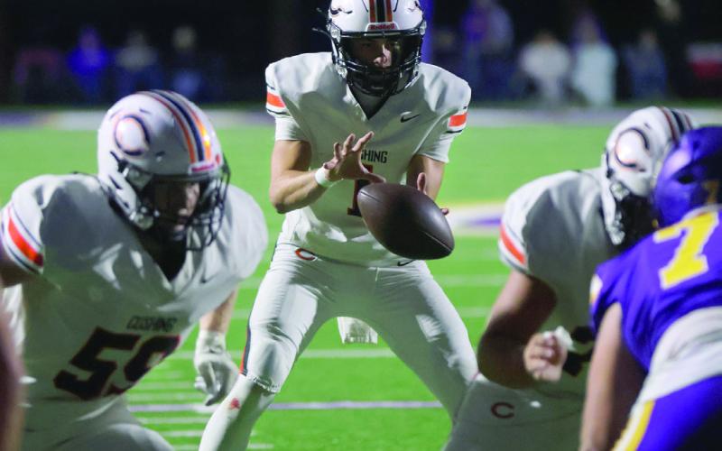 Cushing senior quarterback Roman Tucker takes a snap during the game against the Bristow Pirates Friday night.