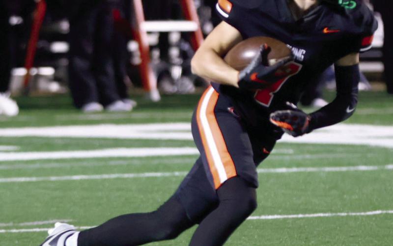 Kellen Fry shifts into high gear and finds open field. Photo by Sylvia Danyele