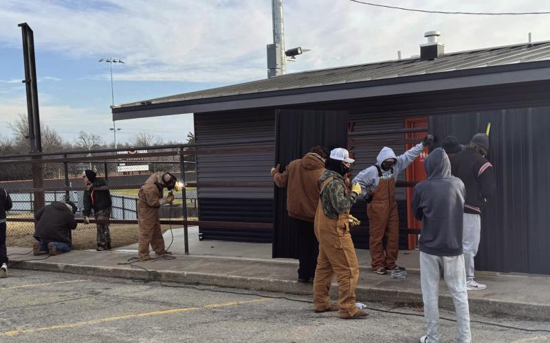 Members of the Cushing Tiger Baseball team and the Dugout Club work to install a new blackout fence along the flanks of the Cushing Baseball field on Jan. 2. The Dugout Club is hosting a fund-raiser dinner on Jan. 18.
