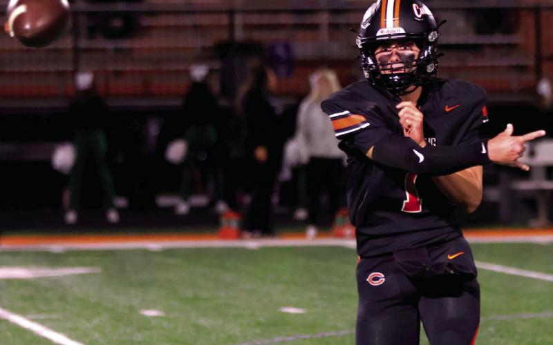 Senior quarterback Roman Tucker makes a pass.