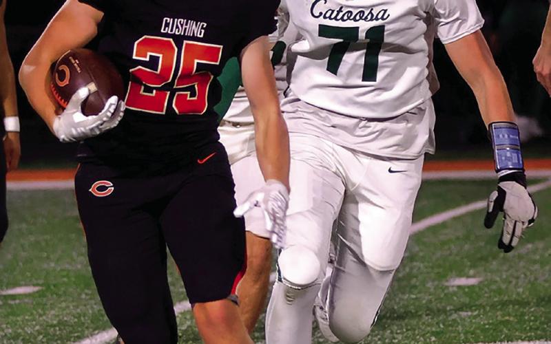 Tiger Freshman Davis Tusler runs past a Catoosa defender.
