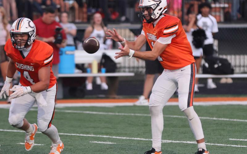Tiger QB Roman Tucker takes a snap.