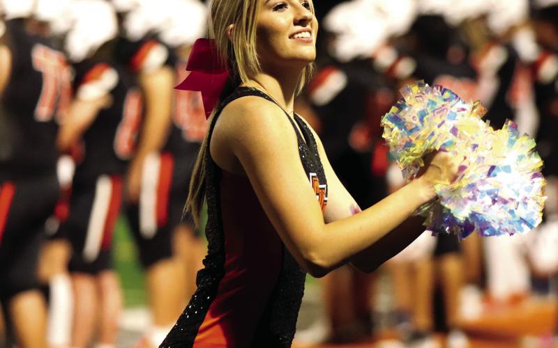 Senior Dancer Ava Babinec drums up spirit on the Tiger sidelines.