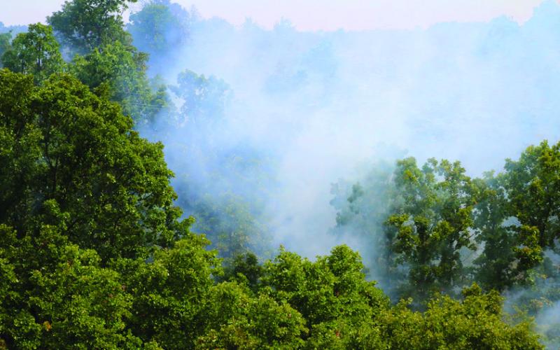 The valley of Rocky Canyon Ranch near 401st smolders during a prescribed burn Friday, Aug. 9. Photo By Allie Prater.