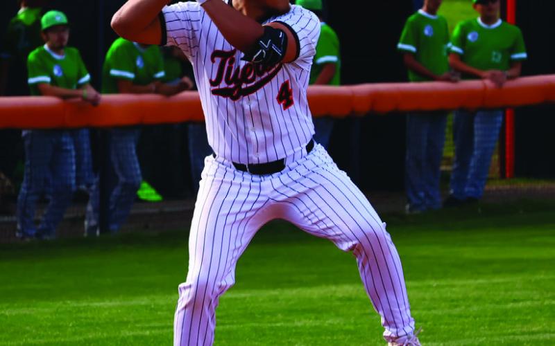 Kellen Fry steps into a solid single against Seminole Monday. Photo by Sylvia Danyele