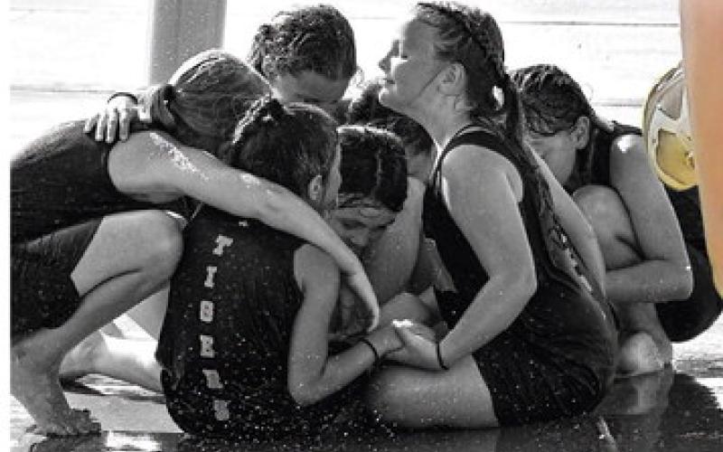 After a stellar performance in the middle-school cross country met in Meeker, several members of the Lady Tiger middle school cross country team cool down at the Meeker Splash Pad. Photo by Sarah Townes