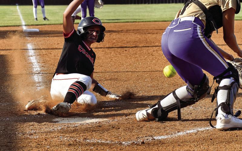 Freshman Macie Townes slides into home. Townes went three for three in the batters box against Davenport, scored one run and had three RBIs. Photos by Sarah Townes