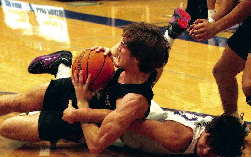 Max Wood goes to the hardwood in a battle for possession. Photos by J. D. Meisner