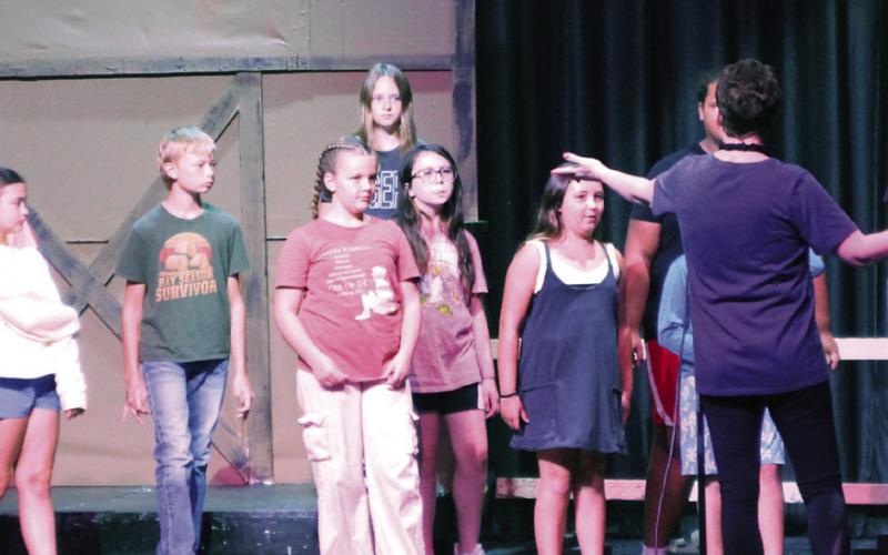 Participants in the Cushing Theatre Camp listen intently to Director Kristin Tarp during rehearsal of their upcoming performance of “Fiddler on the Roof Jr.” scheduled for opening night on July 24.
