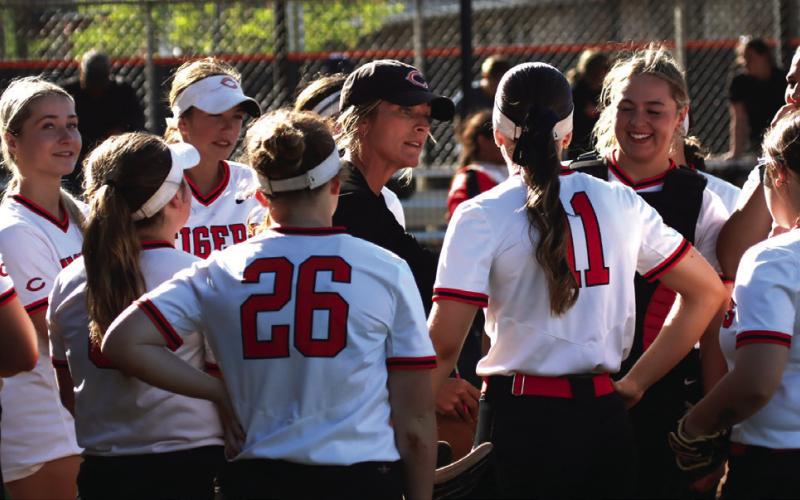 Lady Tiger head coach Nikki York holds a between-inning team conference to strategize during her team’s won over Davenport Thursday. Photo by J. D. Meisner
