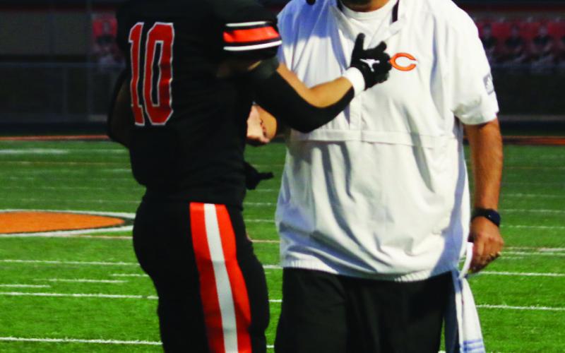 Offensive Coordinator Scott Chisholm congratulates wide receiver Brock Bales after he scored Cushing’s first touchdown of the night Friday.