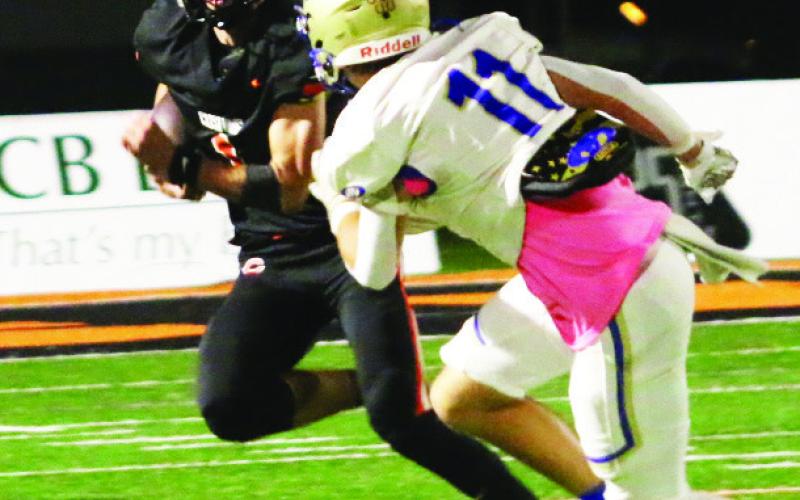 Roman Tucker turns and burns for the sideline. Tucker had 94 yards rushing for the Tigers. Photos by J.D. Meisner
