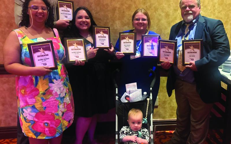 Cimarron Valley Communications staff stand with their first place plaques following the Better Newspaper Contest awards banquet Saturday, June 6 held at the Embassy Suites in Norman. Pictured back row advertising director Jeremy Fincher, middle row lead reporter DeAnna Maddox, accounts and office manager Sapphire Smith, managing editor Allie Prater, owner and publisher J.D. Meisner, front row chief moral officer Jamison Prater. Photo by Caleson Coon.