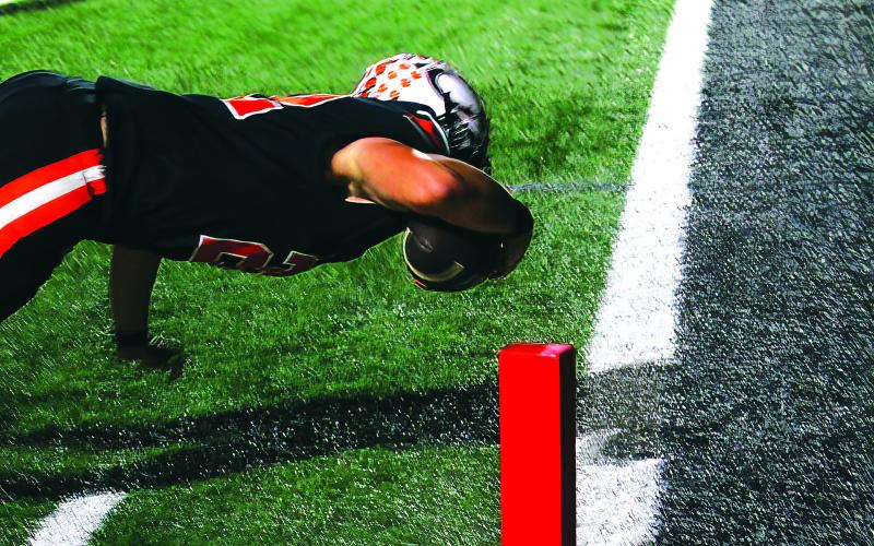 Wyatt Heisler makes a diving touchdown in the second quarter of last weeks win over Ft. Gibson. Photo by J. D. Meisner