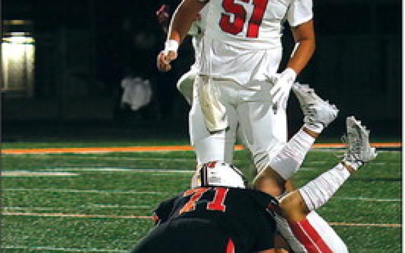 Tiger senior Micael Cruz buries Ft. Gibson quarterback Logan Bethel, Friday.