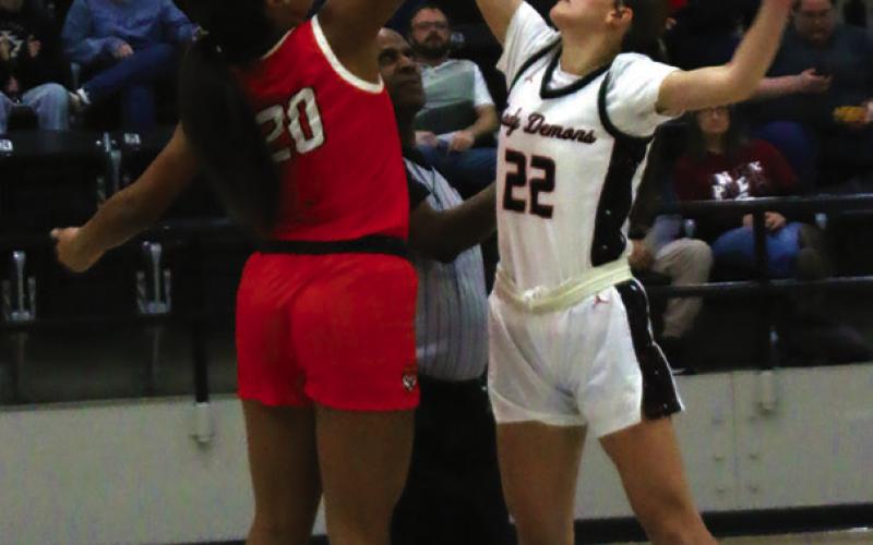 Lady Tiger Ella Nanaeto contests the opening tip against Perkins’ Brynn Stone Friday.