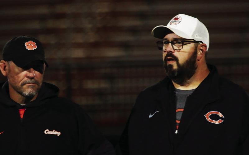 Cushing defensive coordinator Kyle Fry and offensive coordinator Scott Chisholm discuss strategy before the final regular game of the season against Catoosa. Photo by J. D. Meisner