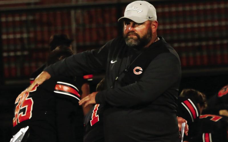 Cushing head coach Rusty Morgan encourages one of his Tigers during pre-game warmup.