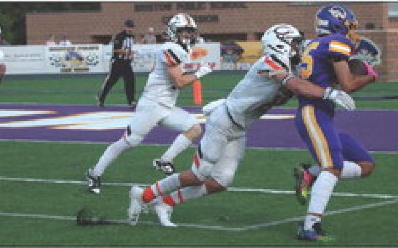 Brady Matheson wraps up a Bristow ball carrier as the Tigers make one of four goal line stands last week against the Bristow Pirates. Coming in for the assist is Tiger senior Carl Peterson. Photos by J.D. Meisner.