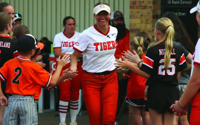 Freshman Talyn Minney is all smiles as she is welcomed onto the field by Cushing Tiger youth athletes. Photo by Allie Prater.