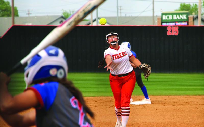 Cushing Lady Tiger Ava Hebensberger throws a pitch to Chandler Lady Lion Brenlee Corea. Photo by Allie Prater.