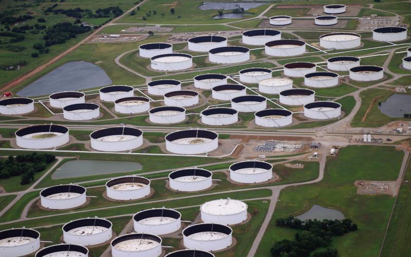 Oil storage tanks at the Cushing hub sit at low capacity. Each tank has a floating lid that rises and falls with the oil inside to prevent product evaporation and buildup of explosive gasses in the headspace. Oil investors and oil market intelligence firms monitor the height of these lids to determine how much oil is in each tank. A lower lid indicates less oil in storage. Photo by Caleson Coon.