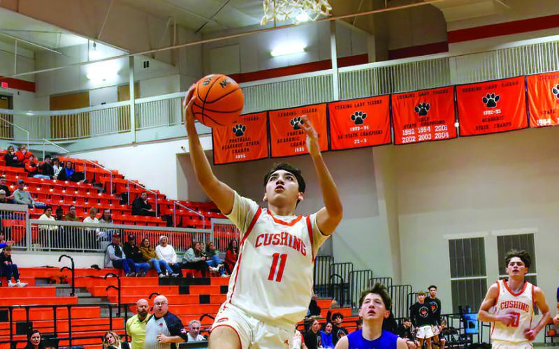 Kanaan Guerrero drains a bucket in transition during the Cushing Tigers defeat of the Mannford Pirates. Guerrero hit the paint hard Friday, scoring 24 points on eight twos and going 8-9 at the free-throw line.