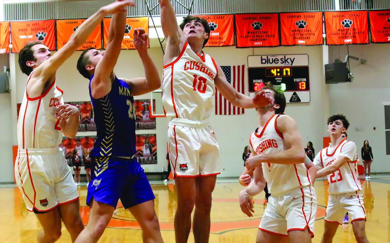 Roman Tucker rejects a shot from Mannford’s Boone Hodson during Friday’s district championship game. Photos by J.D. Meisner