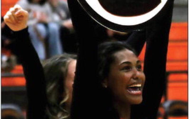 Juliana Schuler proudly cheers on the Tigers during the district championship game Friday.