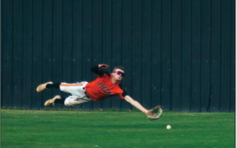Stetson Ethridge gives 110 percent going for an unreachable fy ball in the outfield.