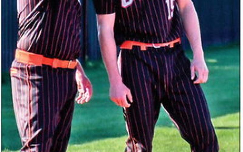 “Everything the light touches is our kingdom.” “What’s that shadowy place?” “That’s the loser’s bracket. Tigers never go there.” Tiger head coach Bryce Scalf gives some third-base advice to Tiger Roman Tucker.