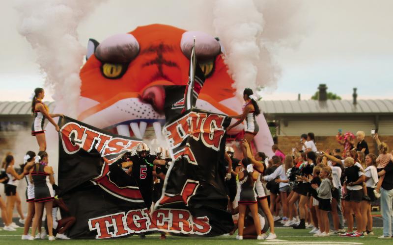 Tiger running back Cole Cooper breaks the seal on the 2024-25 football season during the Tiger runout prior to Cushing’s 18-7 win over Berryhill. Photos by J. D. Meisner