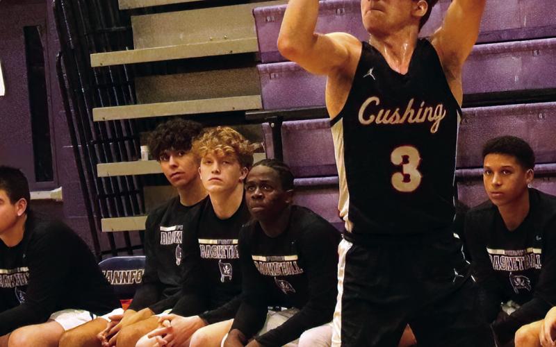 Sophomore Curtis Parmley lines up a three pointer against Mannford.
