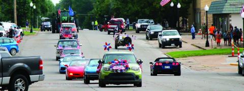 Busy Bee Floral leads a string of would-be parade participants down Broadway following the cancellation of the parade on July 4th. Photo by Allie Prater.