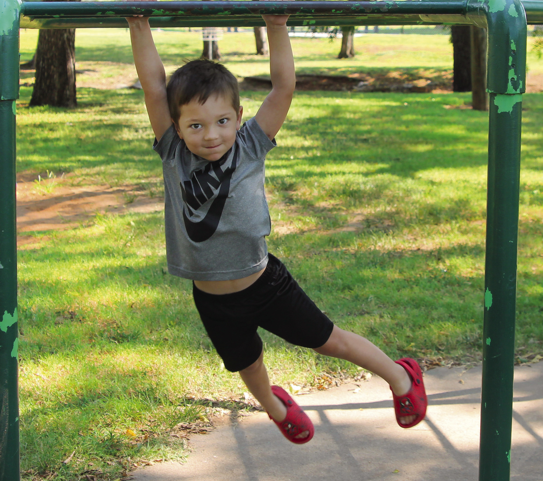 Before starting preschool at Oak Grove, Jack McDougal was at Memorial Park this Tuesday to conquer the monkey bars; a feat his granny and gramps said every young boy needed to achieve. He managed a jump and catch of the bar and even a bit of a swing. His sister had her own version — running under the bars with her hands raised. Photo by DeAnna Maddox