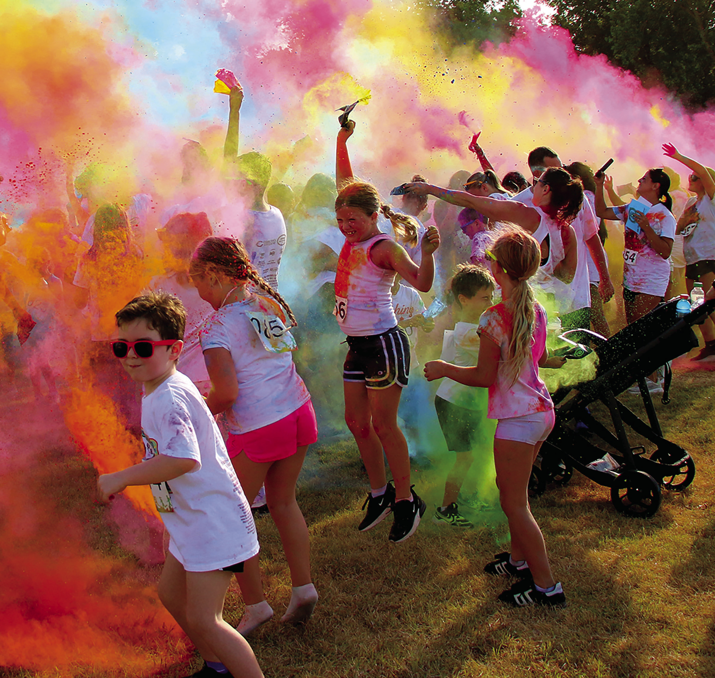 Participants in the Cushing Geographic Club’s Do or Dye fundraiser color run cause a color explosion in Memorial Park Saturday, Aug. 16 following the race. Photo by Allie Prater. 