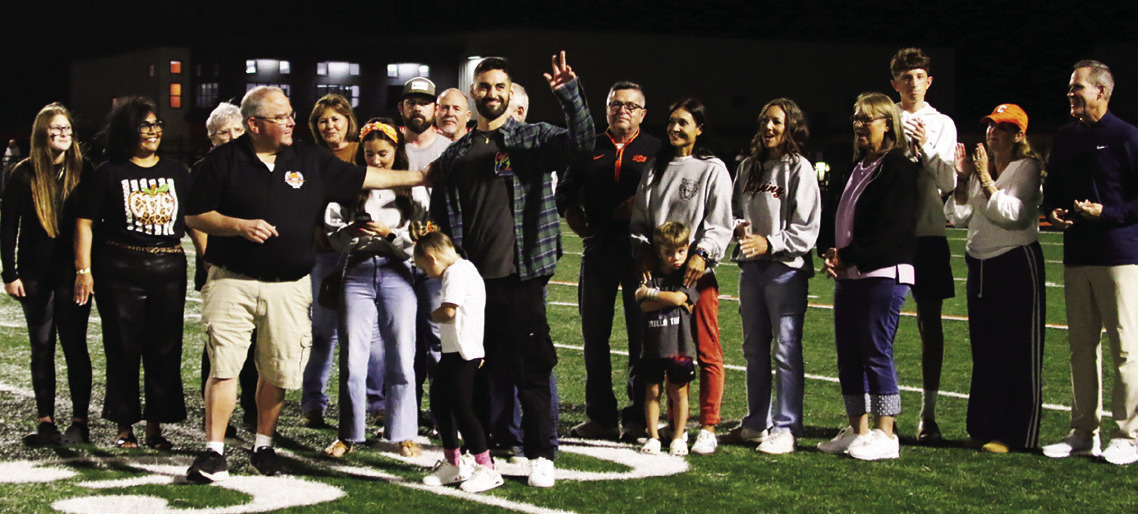 Cushing Alum Travis Peery congratulates Justin Bogle while his family and friends join in celebrating his induction into the Cushing Hall of Fame. Bogle made his way to the very pinnacle of Supercross racing in America and abroad. Pboto by J. D. Meisner