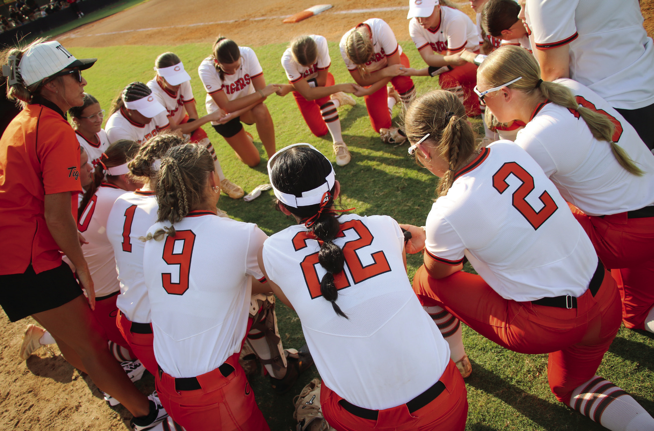 The Cushing Lady Tigers circle up for a pregame pep talk from Lady Tiger Head Coach Nikki York before the Lady Tigers took on the Davenport Lady Bulldogs in the season opener Monday, Aug. 10. See inside for more details. Photo by Allie Prater.