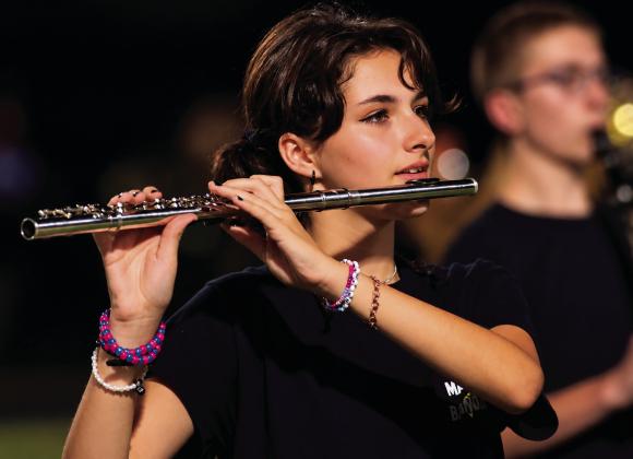 Sophomore flutist Miley Donathan performs with the CHS marching band during the halftime performance Friday, Sept. 4. Photo by J. D. Meisner.