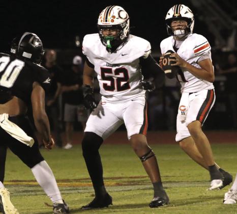 Eric Garrido provides protection for Cushing quarterback Gabe Gurley, who completed 17 of 27 passes for 195 yards and a touchdown against Perkins-Tryon, while adding 50 yards and another touchdown on seven carries. Photo by J. D. Meisner