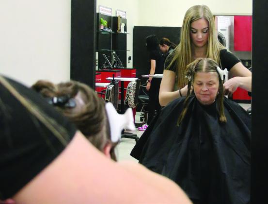 First year cosmetology student at Central Tech and Yale High School junior RyLee Reece cuts Kenna Conners’, of Bristow, hair during the Central Technology Center Open House on Sunday, Feb. 18. Photo by Allie Prater
