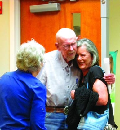 Lee Roy Kalka shares a hug with one of his daughters, Sherry, after stepping into what he was led to believe was a Cushing Regional Hospital Foundation meeting on Aug. 19 at the Cushing Hillcrest Hospital. Photo by DeAnna Maddox.