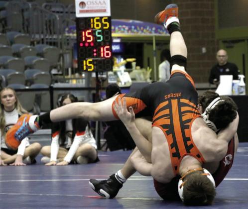 Cushing wrestler Iziah Tusler flips over Tuttle Tiger Rylend Slover during the championship match at the OSSAA Dual State Tournament held Friday, Feb. 9. Tusler won over Slover by decision 9-4. Photos by Allie Prater.