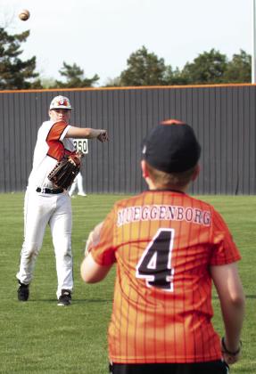 It was youth night at Tiger field Monday when the Cushing varsity baseball team hosted and warmed up with participants in Cushing’s youth baseball leagues. Above, Tiger Cooper Johnson is warmed by Terrick Meuggenborg, of Yale, who played in the Cushing 10-U league. Photos by J. D. Meisner