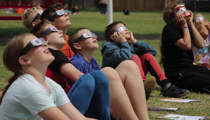 Ms. Munday’s fourth grade class at Cushing Upper Elementary school watch the solar eclipse as it reaches near totality Monday, April 8. Photo by Allie Prater